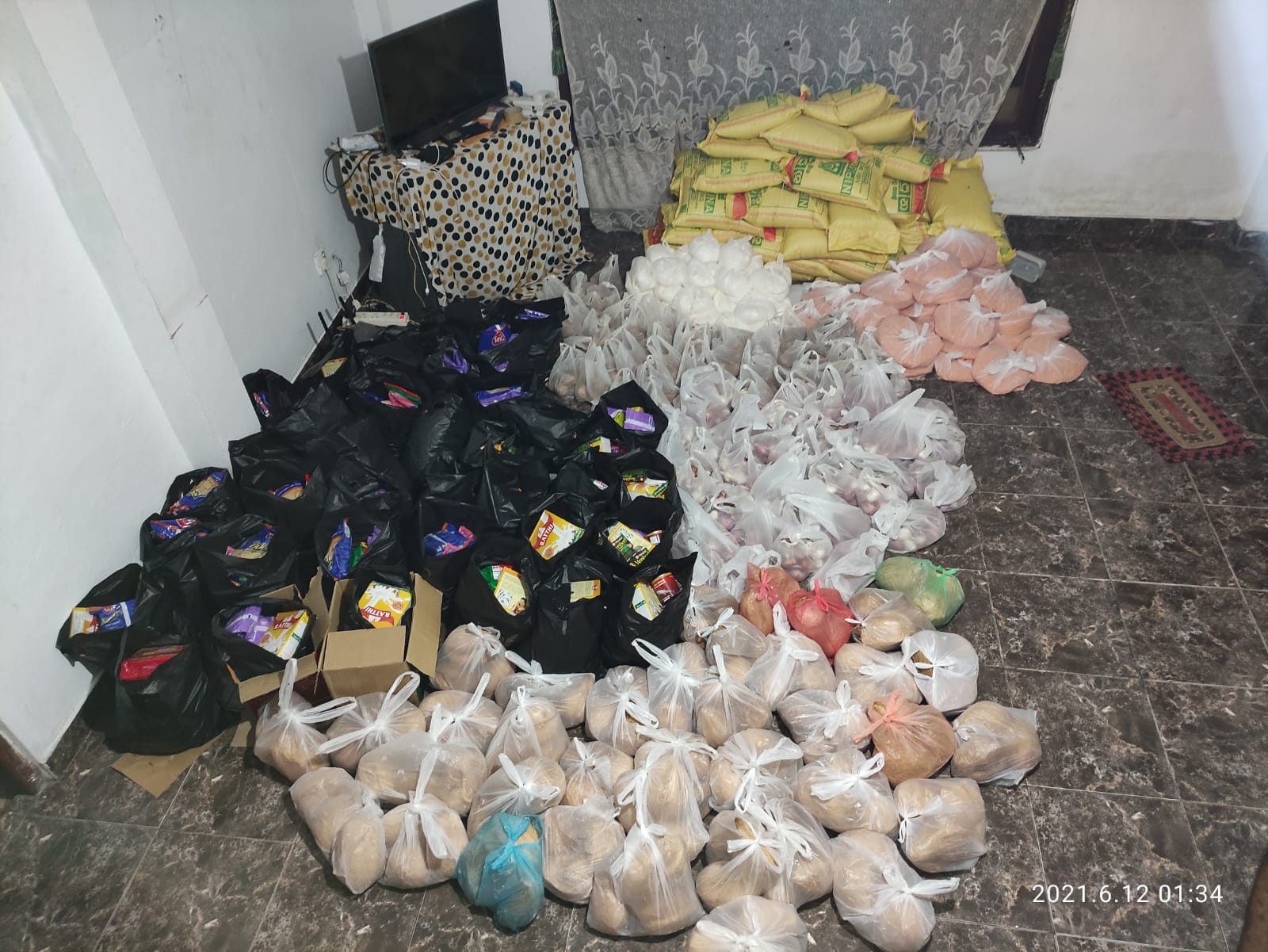 Dry food packs ready for a family in need, 2021